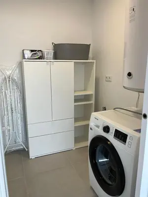 a washing machine sitting next to a white cabinet at Chalet El Eden in Chiclana de la Frontera