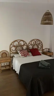 a bedroom with a large bed with red pillows at Apartamento Vista Bahia - Vistahermosa in El Puerto de Santa María