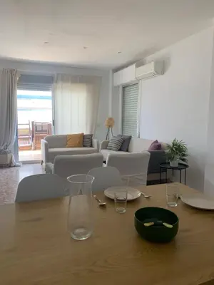 a living room with a table with glasses on it at Apartamento Vista Bahia - Vistahermosa in El Puerto de Santa María