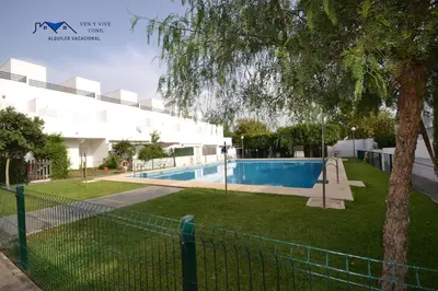 a swimming pool in the backyard of a house at Adosado Familiar con Piscina y Terraza in Cádiz