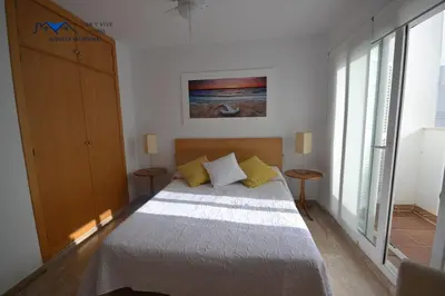 a bedroom with a large bed with yellow pillows at Adosado Familiar con Piscina y Terraza in Cádiz