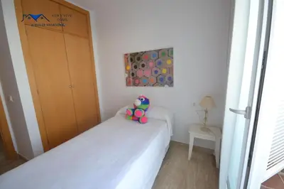 a bedroom with a bed with a stuffed animal on it at Adosado Familiar con Piscina y Terraza in Cádiz