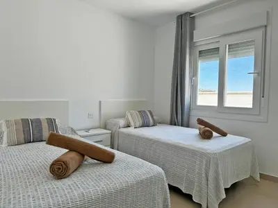 a bedroom with two beds and a window at Villa Tresoles - Ole Solutions in Conil de la Frontera