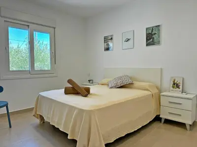 a white room with a bed and a window at Villa Tresoles - Ole Solutions in Conil de la Frontera