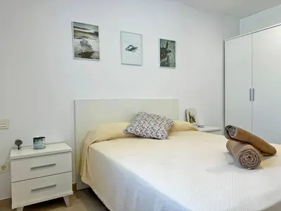 a white bedroom with a bed and a dresser at Villa Tresoles - Ole Solutions in Conil de la Frontera