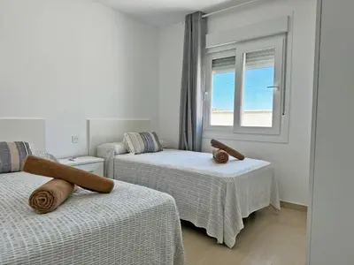 a bedroom with two beds and a window at Villa Tresoles - Ole Solutions in Conil de la Frontera