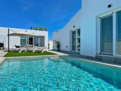 a swimming pool in front of a house at Villa Tresoles - Ole Solutions in Conil de la Frontera