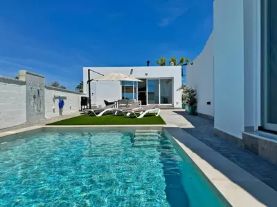 a swimming pool in front of a house at Villa Tresoles - Ole Solutions in Conil de la Frontera