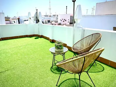 two chairs and a table on a roof at Casa Castelar in Rota
