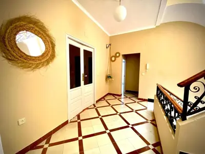 a hallway with a door and a checkered floor at Casa Castelar in Rota