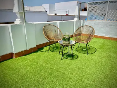 two chairs and a table on a roof at Casa Castelar in Rota
