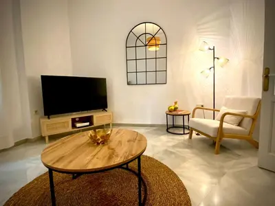 a living room with a television and a coffee table at Casa Castelar in Rota