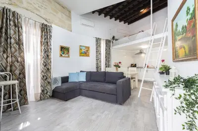 a living room with a couch and a table at Casa Antonia I in Jerez de la Frontera