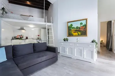a living room with a couch and a loft bed at Casa Antonia I in Jerez de la Frontera
