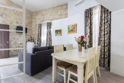 a living room with a table and a couch at Casa Antonia I in Jerez de la Frontera