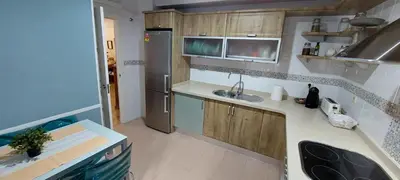 a small kitchen with a sink and a refrigerator at Apartamento La Porteña, 200 ms de playa Victoria in Cádiz