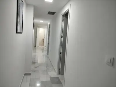 a hallway with white walls and a tile floor at Barrameda 19 in Sanlúcar de Barrameda