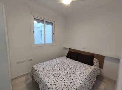 a bedroom with a bed and a window at Barrameda 19 in Sanlúcar de Barrameda