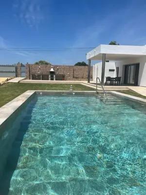 a swimming pool in front of a house at Chalet Namasté in Conil de la Frontera