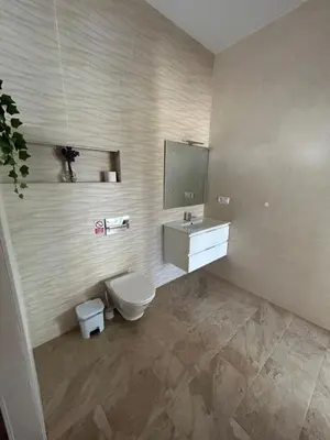 a bathroom with a toilet and a sink and a mirror at Chalet Namasté in Conil de la Frontera