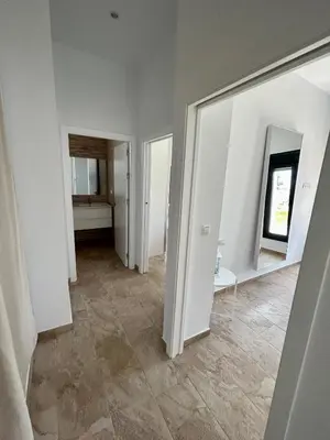 an empty room with white walls and tile floors at Chalet Namasté in Conil de la Frontera