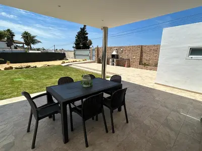 a black table and chairs on a patio at Chalet Namasté in Conil de la Frontera