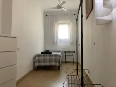 a white room with a bed and a window at Casa Carmela - PÓPULO in Cádiz