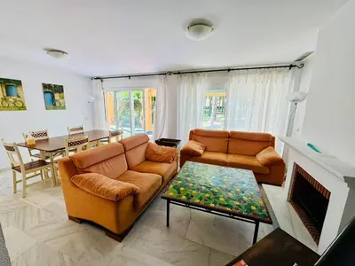 a living room with two couches and a table at Hoyo 27 con Piscina Grupo AC Gestión in Chiclana de la Frontera