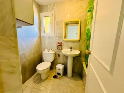 a small bathroom with a toilet and a sink at Hoyo 27 con Piscina Grupo AC Gestión in Chiclana de la Frontera