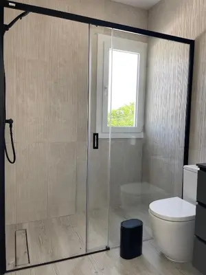 a bathroom with a shower with a toilet and a window at Casa Bahía de Cádiz in Conil de la Frontera