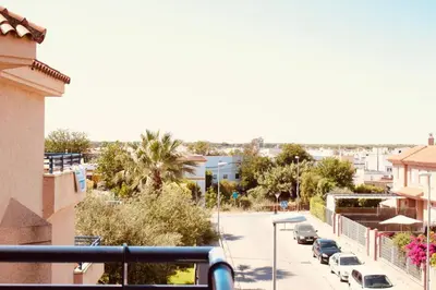 a city street with cars parked on the street at Albatros Sanlucar in Sanlúcar de Barrameda