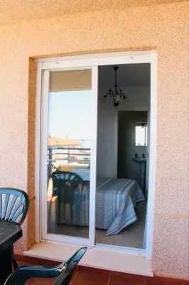 a room with a window with a bed in it at Albatros Sanlucar in Sanlúcar de Barrameda
