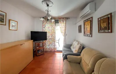 a living room with a couch and a tv at Lovely Apartment In Chiclana De La Front in Poblado de Sancti Petri