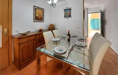 a dining room with a glass table and chairs at Lovely Apartment In Chiclana De La Front in Poblado de Sancti Petri