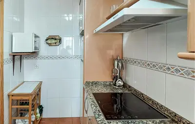 a kitchen with a sink and a counter top at Lovely Apartment In Chiclana De La Front in Poblado de Sancti Petri
