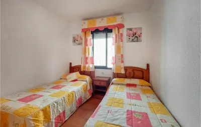 a bedroom with two beds and a window at Lovely Apartment In Chiclana De La Front in Poblado de Sancti Petri