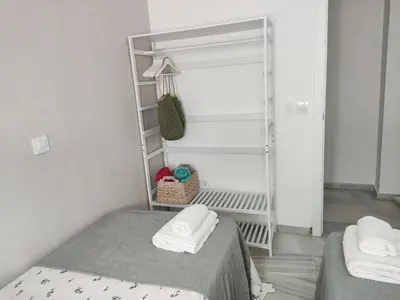 a small bedroom with a bed and a ladder at Casa Bermeo in Sanlúcar de Barrameda