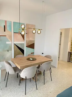 a dining room with a wooden table and chairs at Sanlúcar Urban Apartment in Sanlúcar de Barrameda