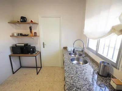 a kitchen with a sink and a window at Sanlúcar Urban Apartment in Sanlúcar de Barrameda