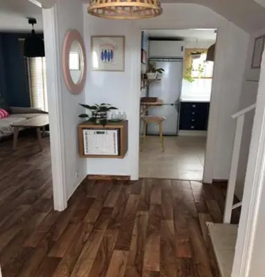 a living room with a hard wood floor and a hallway at VILLA MARISMAS DE LA ALMADRABA in Chiclana de la Frontera
