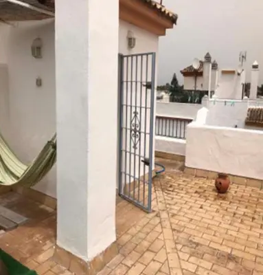 a gate on the side of a building at VILLA MARISMAS DE LA ALMADRABA in Chiclana de la Frontera