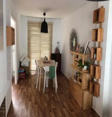 a living room with a table and a dining room at VILLA MARISMAS DE LA ALMADRABA in Chiclana de la Frontera