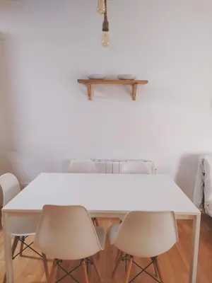 a white table and chairs in a room at APARTAMENTO SEGUNDA PLANTA in Chiclana de la Frontera