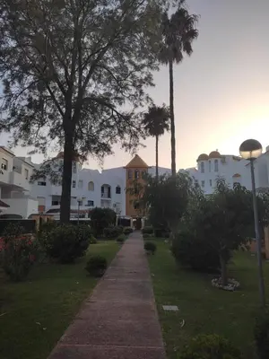 a walkway in front of some white buildings at APARTAMENTO SEGUNDA PLANTA in Chiclana de la Frontera