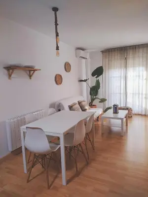 a living room with a white table and a couch at APARTAMENTO SEGUNDA PLANTA in Chiclana de la Frontera