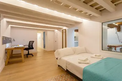 a bedroom with a bed and a desk and a chair at Estudio Amor BRUJO by Cadiz4Rentals in Cádiz