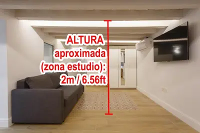 a room with a couch and a sign on the wall at Estudio Amor BRUJO by Cadiz4Rentals in Cádiz