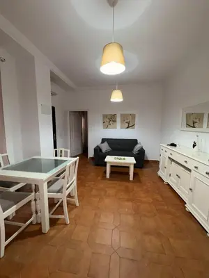 a living room with a table and a couch at Casa Antonia II in Jerez de la Frontera