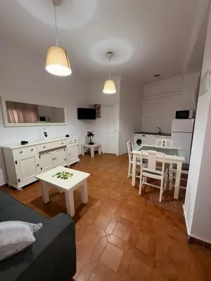 a living room with a table and a kitchen at Casa Antonia II in Jerez de la Frontera