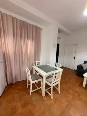 a white table and chairs in a living room at Casa Antonia II in Jerez de la Frontera